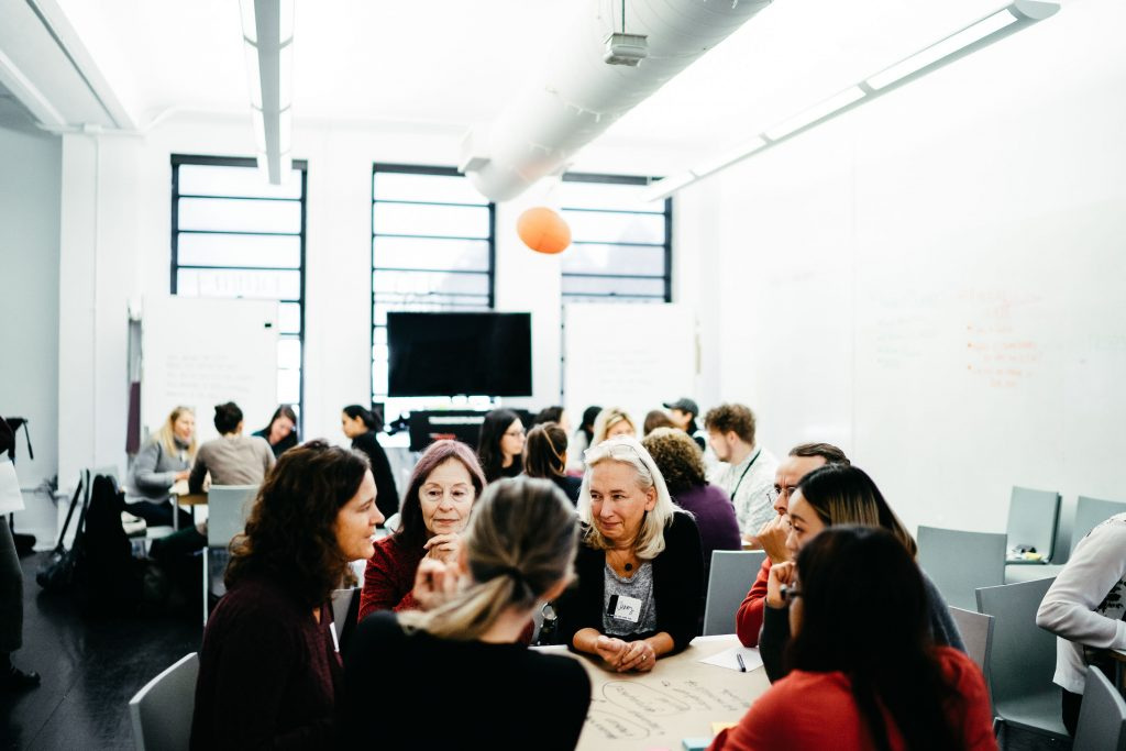 Participants in conversation around tables at the End of Life Festival workshop