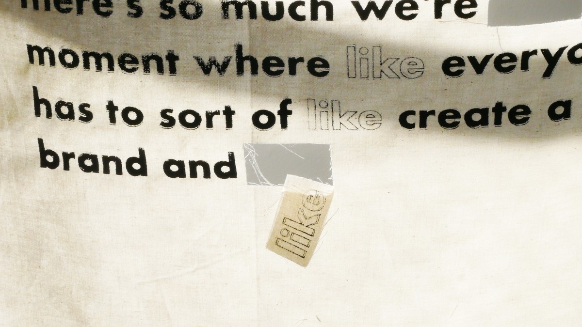 Silkscreened transcript on fabric reading 'moment where everyone has to sort of create a brand and'